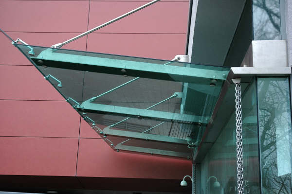 A wall suspended Glass canopy